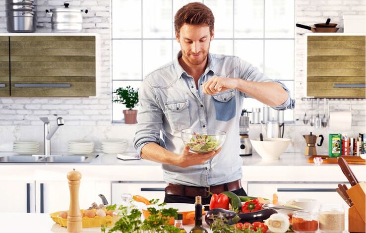 man prepares vegetable salad to increase potency